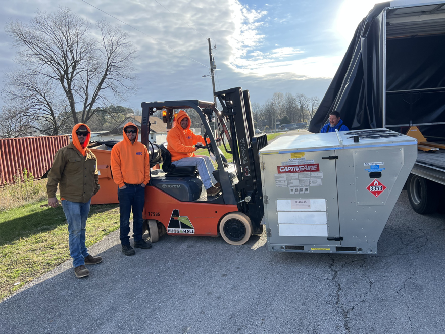 The HBC HVAC team using a forklift to safely unload a large HVAC unit from a truck in Cranston, RI.