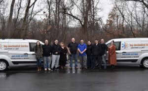 The dedicated HVAC team standing proudly with their service vans from Top Mechanical Service in East Longmeadow, MA.