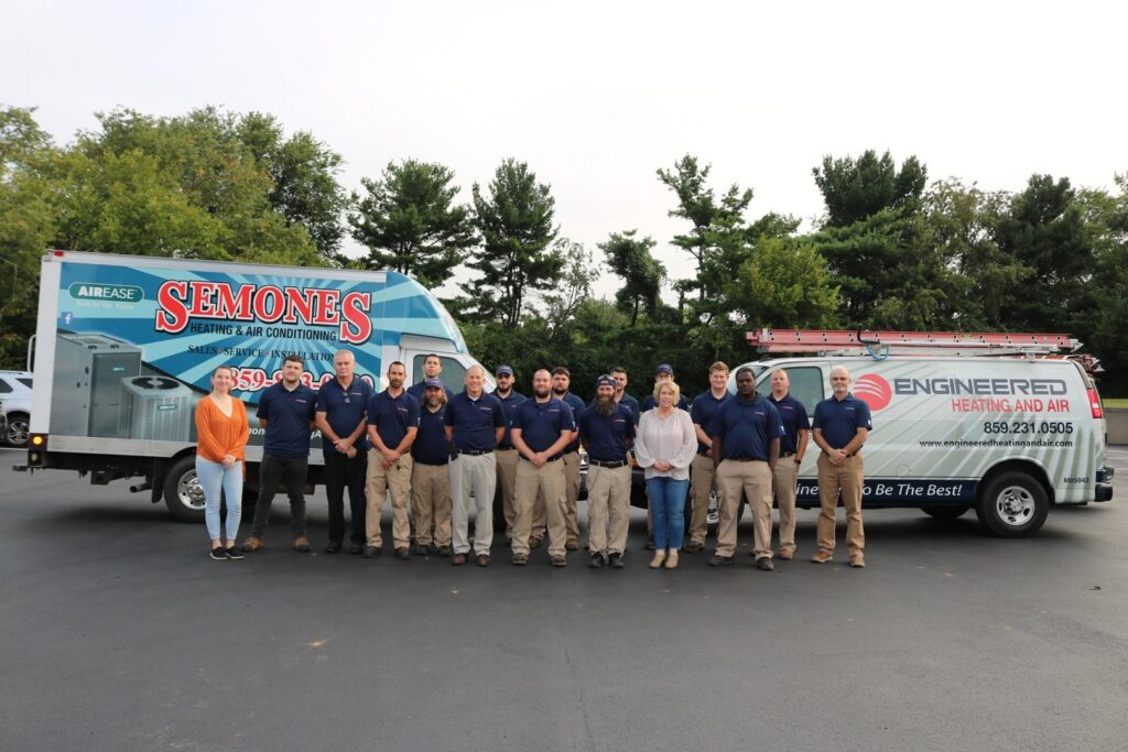 Combined HVAC teams from Semones and Engineered Heating and Air with their service vehicles for Leap Partners in Greensboro, NC.