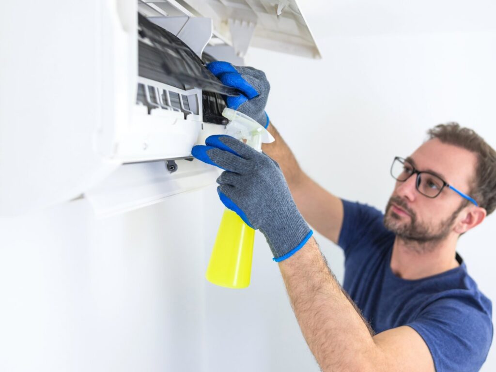 An HVAC technician diagnosing an outdoor AC unit with gauges for ChillTek AC Repair Glendale in Glendale, AZ.