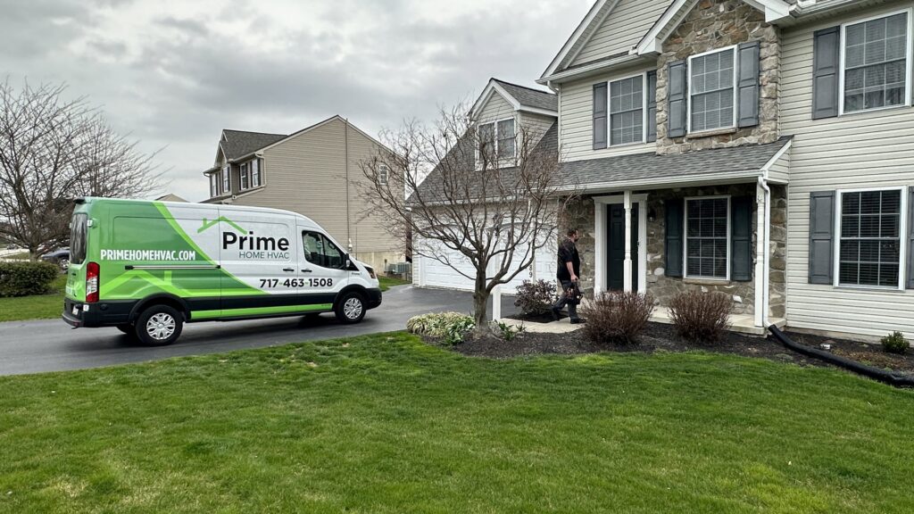 A Prime Home HVAC technician walking towards a customer's home, ready to begin an HVAC service job in York, PA.