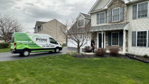 A Prime Home HVAC technician walking towards a customer's home, ready to begin an HVAC service job in York, PA.