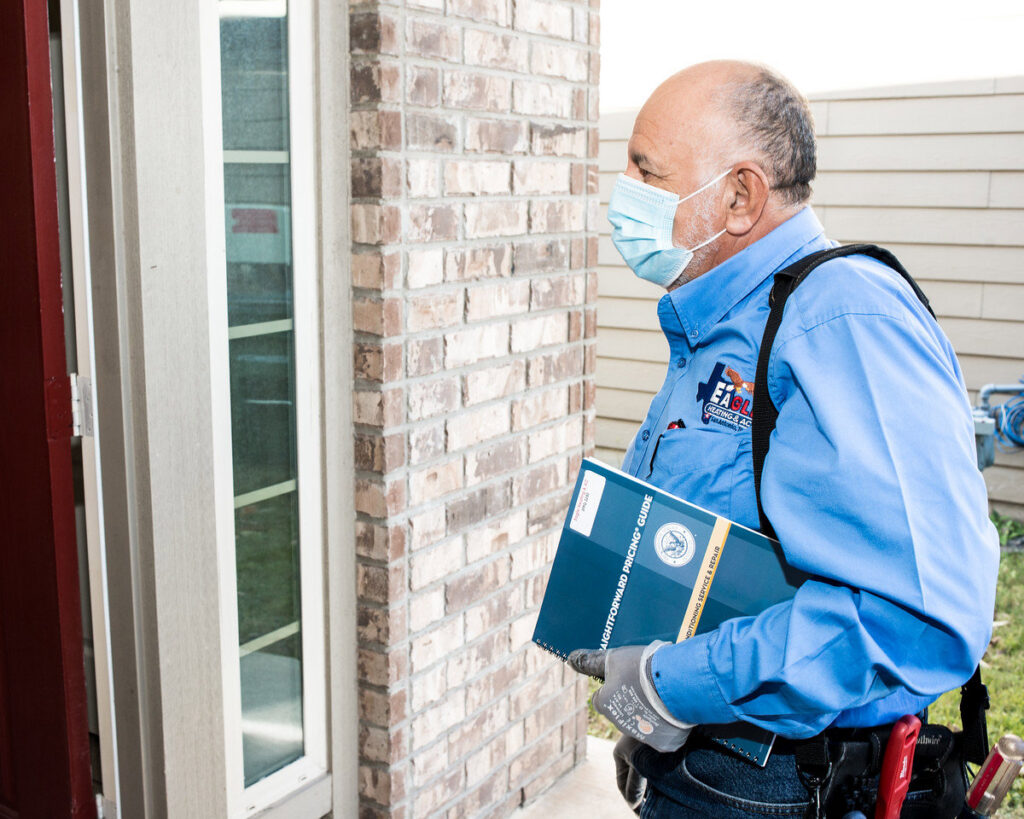 An HVAC technician from Eagle Heating & A/C arriving for a service call at a residential home in San Antonio, TX.
