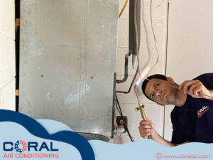 An HVAC technician from Coral Air Conditioning brazing copper refrigerant lines during an installation in Cape Coral, FL.