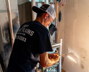 An HVAC technician from Great Plains Heating & Air brazing a unit during service or installation in Goddard, KS.