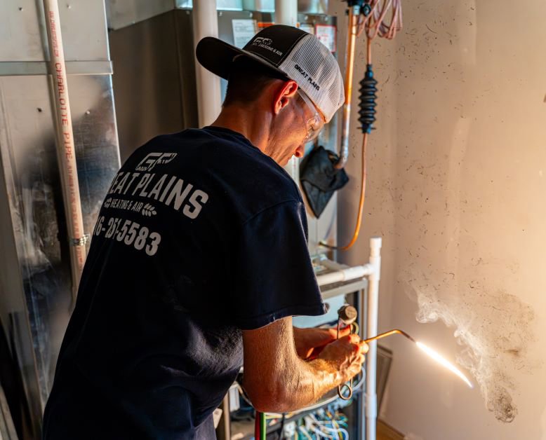 An HVAC technician from Great Plains Heating & Air brazing a unit during service or installation in Goddard, KS.