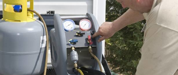 An HVAC technician operating refrigerant charging equipment for AC Repair DC in Washington, DC