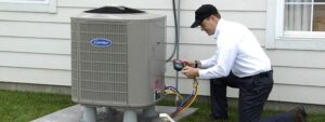 An HVAC technician checking refrigerant levels on an outdoor AC unit for AC Plus Heating & Air Conditioning Service in Las Vegas, NV.