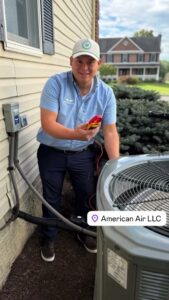 An HVAC technician from American Air LLC checking an outdoor AC unit with a multimeter in Moncks Corner, SC