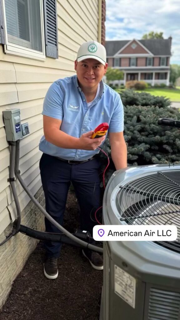 An HVAC technician from American Air LLC checking an outdoor AC unit with a multimeter in Moncks Corner, SC