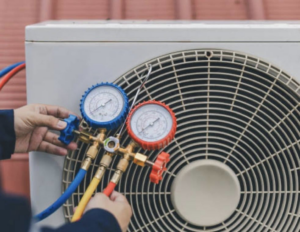 An HVAC technician checking refrigerant levels on an outdoor AC unit at Thompson Heating & Cooling in Page, AZ