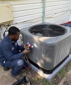An HVAC technician checking an outdoor AC unit with gauges for RESTQ HVAC Repairs & Services in Rockville, MD.