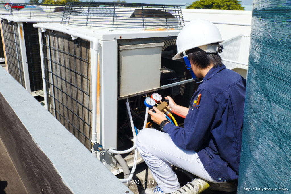 An HVAC technician checking refrigerant levels on a commercial rooftop unit for Controlled Climates Heating and Air Conditioning, Inc. in Fresno, CA.