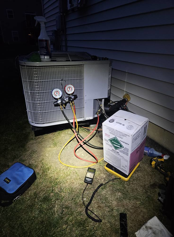 An HVAC technician checking refrigerant levels on an outdoor condenser unit for Dr. Cool Climate Control HVAC in Las Vegas, NV.