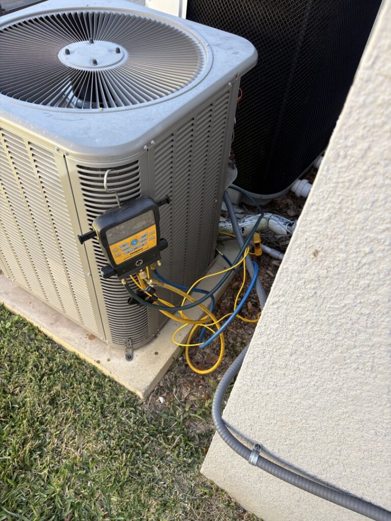 An HVAC technician checking refrigerant levels on an outdoor AC unit for Timely Air Conditioning in Riverview, FL.
