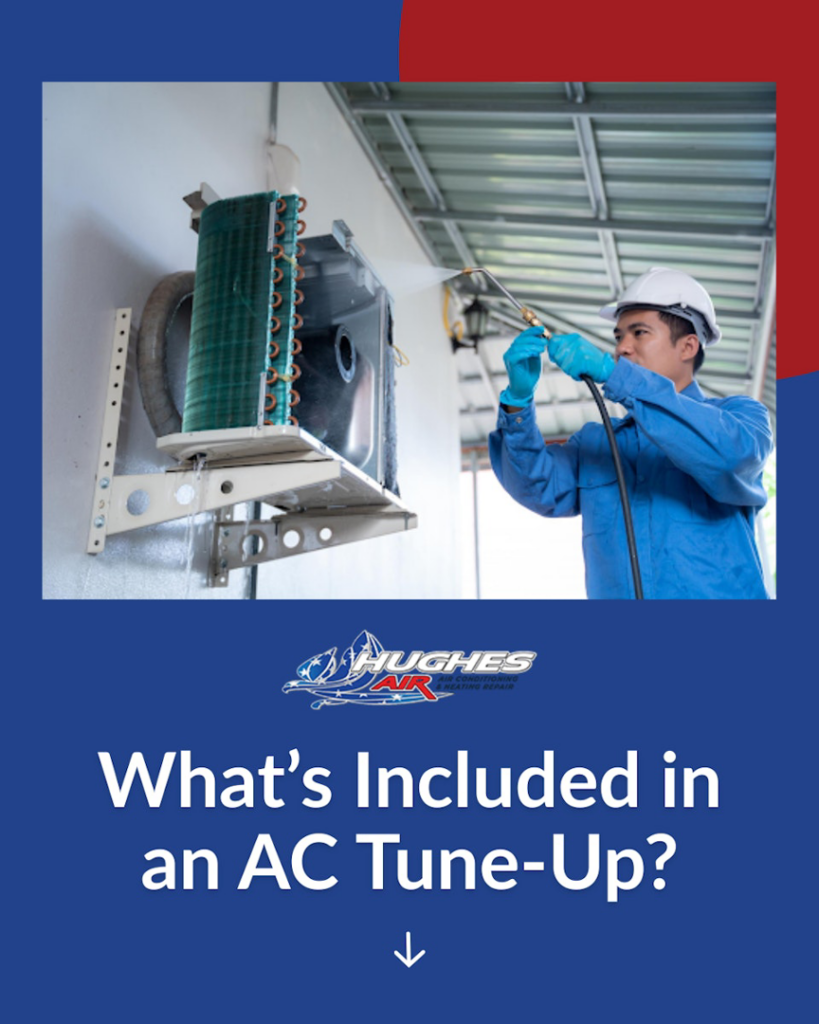 An HVAC technician cleaning an indoor AC coil during a tune-up by Hughes Air Heating & Cooling in Mesa, AZ.