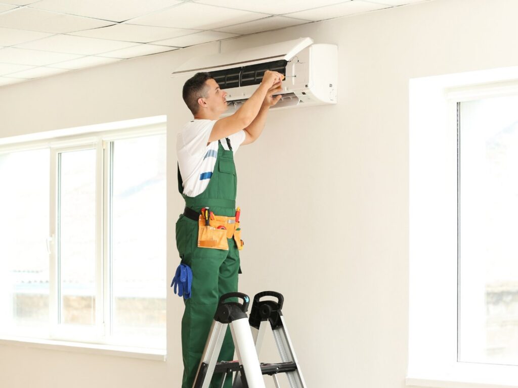 An HVAC technician cleaning an AC filter with spray for ChillTek AC Repair Glendale in Glendale, AZ.