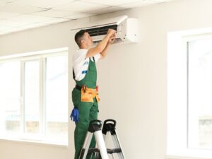 An HVAC technician cleaning an AC filter with spray for ChillTek AC Repair Glendale in Glendale, AZ.