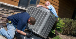 An HVAC technician cleaning a ceiling-mounted AC unit for Taylor & Tyler HVAC Repair Contractors in New Orleans, LA.