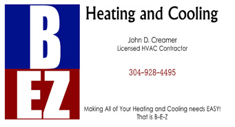 An HVAC technician from BEZ Heating and Cooling, LLC John Creamer, next to a commercial rooftop unit in Huntington, WV.