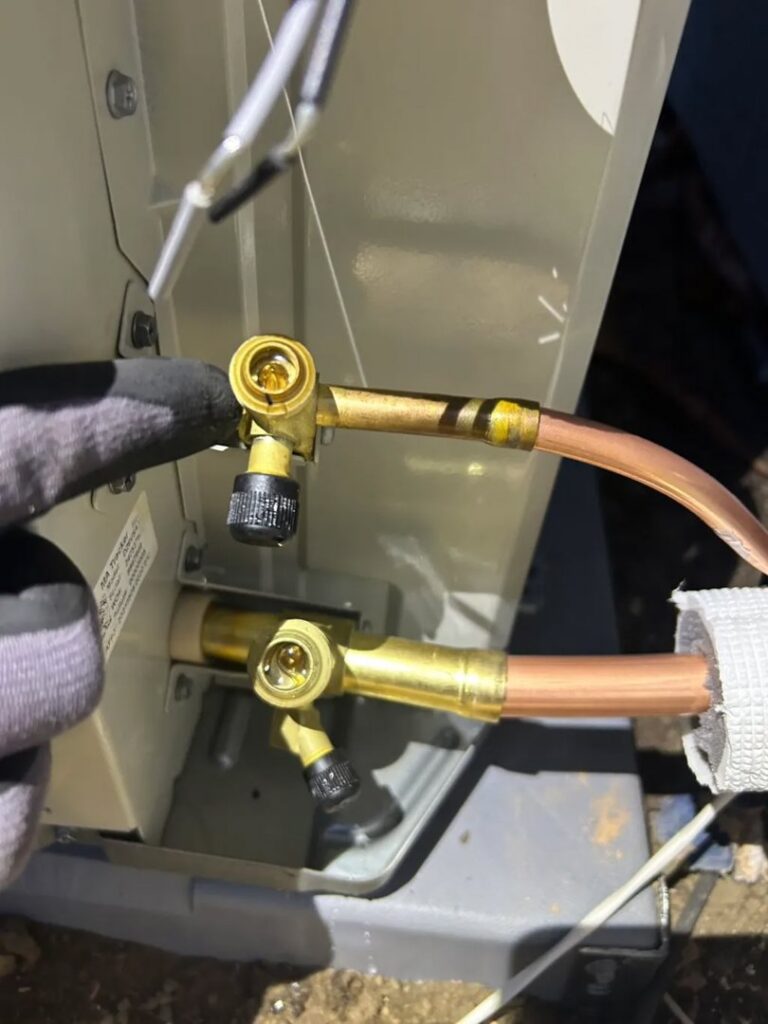 An HVAC technician from Fuse HVAC & Appliance Repair Boston connecting refrigerant lines in West Roxbury, MA.