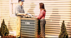 An HVAC technician consulting with a homeowner next to an outdoor AC unit from AC Plus Heating & Air Conditioning Service in Las Vegas, NV.