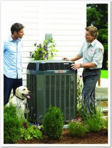 An HVAC technician from Arrowhead Heating & Air Conditioning consulting with a homeowner about an outdoor unit in Casper, WY.