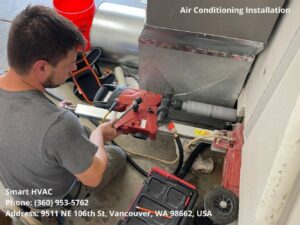 An HVAC technician core drilling for air conditioning installation at a job site for Smart HVAC LLC in Vancouver, WA.