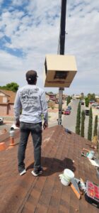An HVAC technician overseeing a unit being lifted by a crane for One Way Heating And Cooling, LLC in Horizon City, TX.