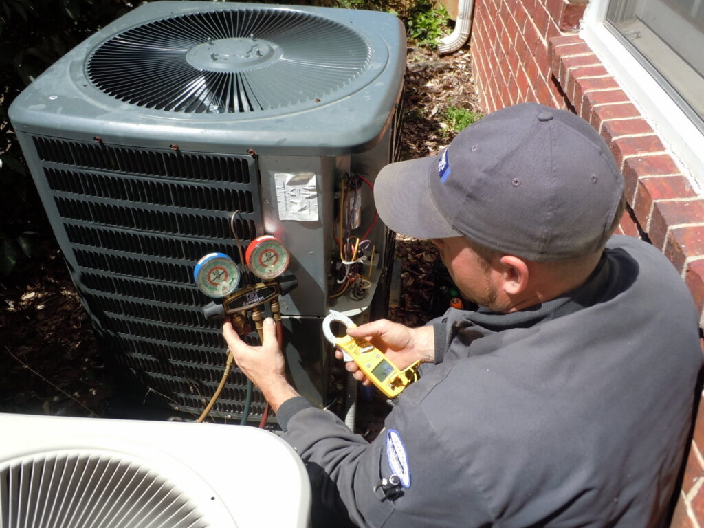 An HVAC technician diagnosing an issue on an outdoor AC unit for AC Plus Heating & Air Conditioning Service in Las Vegas, NV.