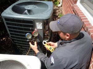 An HVAC technician diagnosing an issue on an outdoor AC unit for AC Plus Heating & Air Conditioning Service in Las Vegas, NV.