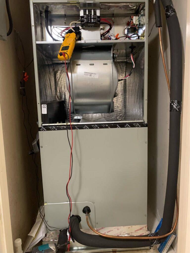 An HVAC technician from Eagle Heating & A/C diagnosing an indoor furnace or air handler unit in San Antonio, TX.