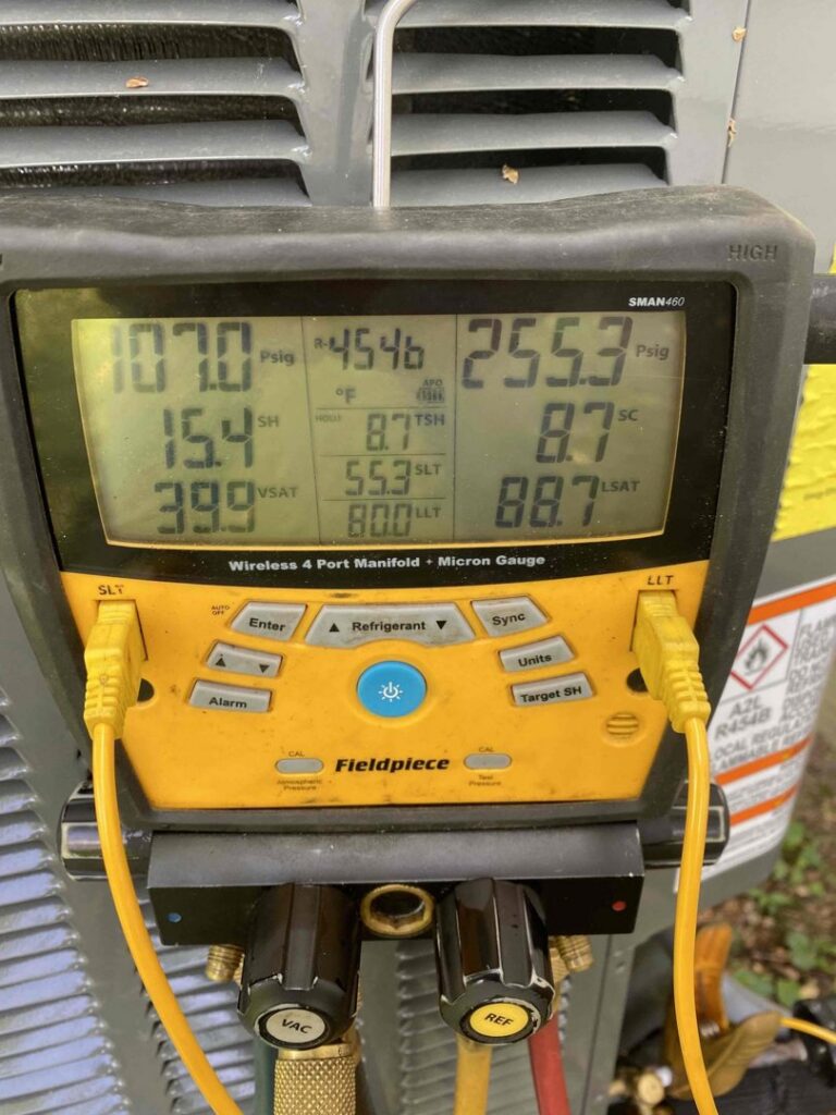 A close-up of a digital manifold gauge set showing readings during HVAC service by MMI Climate Solutions in Lexington, KY.