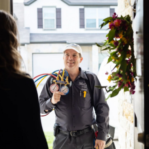 An HVAC technician from Mr. Cool HVAC greeting a customer at their home, holding diagnostic gauges in Cypress, TX.