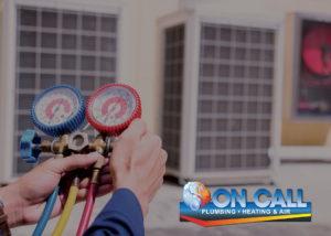 An HVAC technician holding manifold gauges for an outdoor unit service at On Call Plumbing, Heating & Air in Columbia, SC