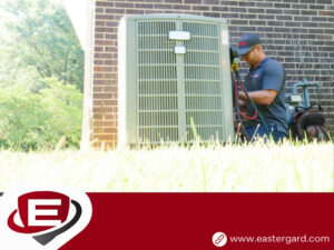 A skilled Eastergard HVAC technician inspecting an outdoor AC unit with tools in Greenville, SC.