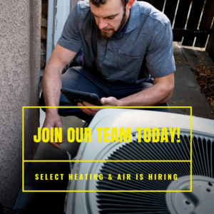 An HVAC technician inspecting an outdoor air conditioning unit for Select Heating & Air, Inc in Lincoln, NE.