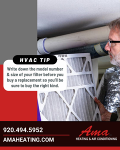 An HVAC technician inspecting an air filter for a client at Ama Heating & Air Conditioning in Green Bay, WI.