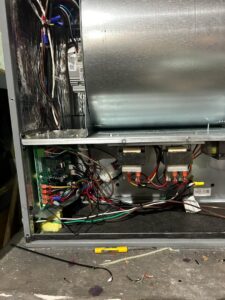 An HVAC technician from Fuse HVAC & Appliance Repair Boston inspecting indoor unit wiring in West Roxbury, MA.