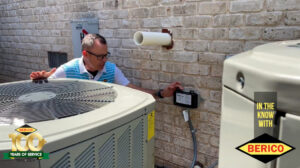 An HVAC technician inspecting an outdoor air conditioning unit and electrical box for Berico in Greensboro, NC