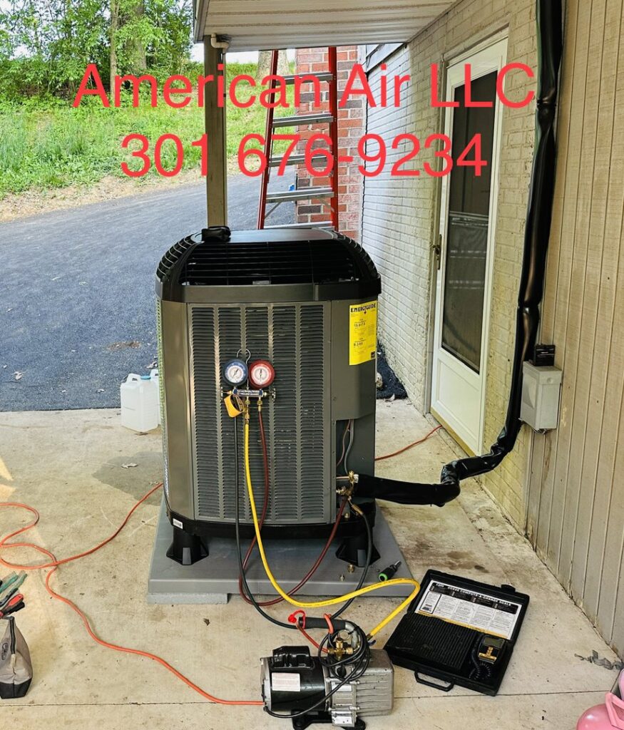 An HVAC technician from American Air LLC installing an AC unit, connected to gauges and a vacuum pump, in Moncks Corner, SC