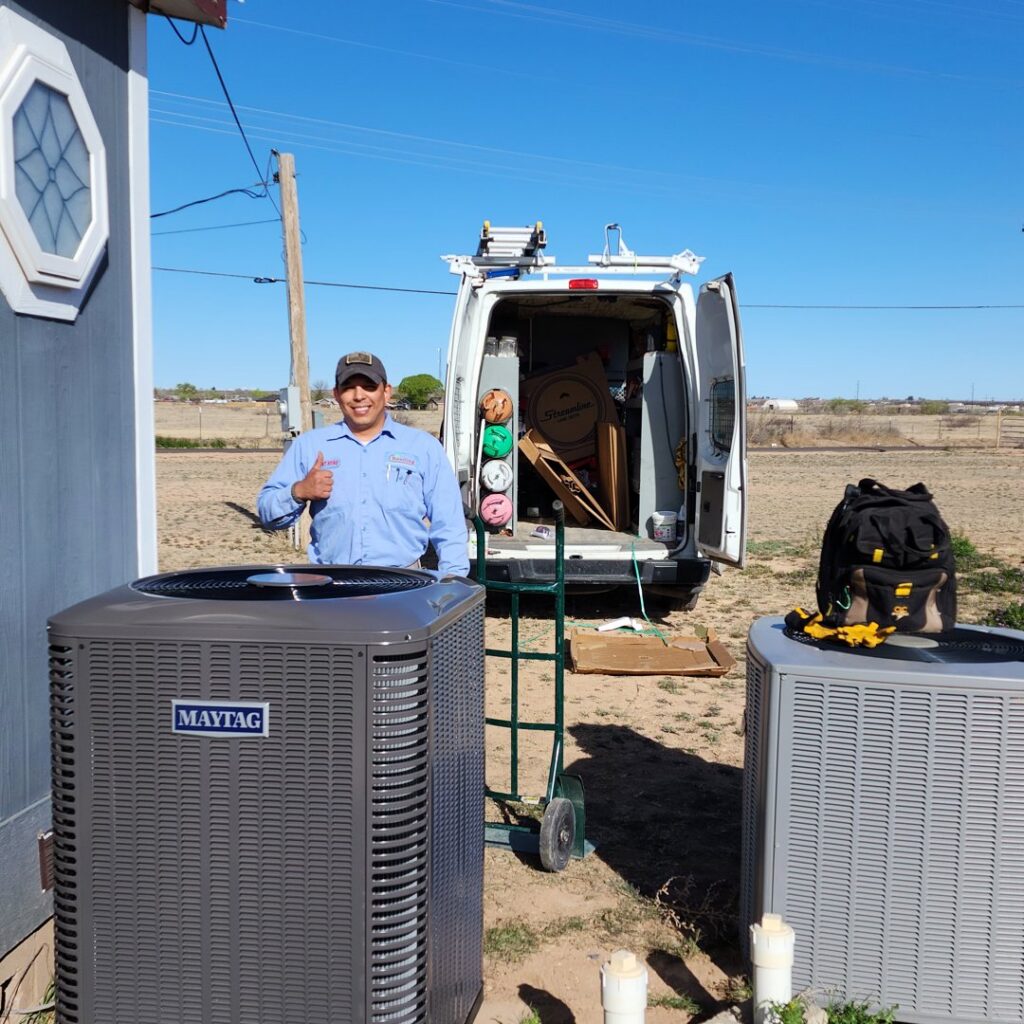 An HVAC technician installing new air conditioning units for Reading Plumbing, Heating & Air Conditioning in Roswell, NM