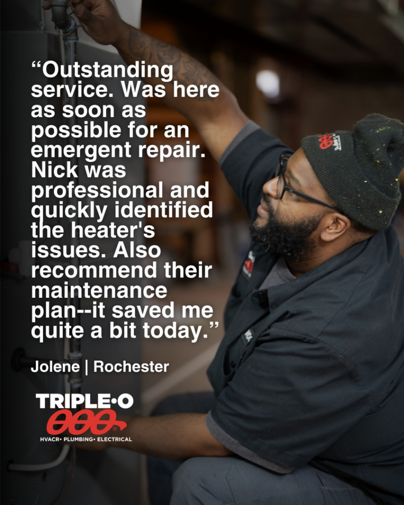 An HVAC technician from Triple-O installing a mini-split air conditioning unit in Bergen, NY.