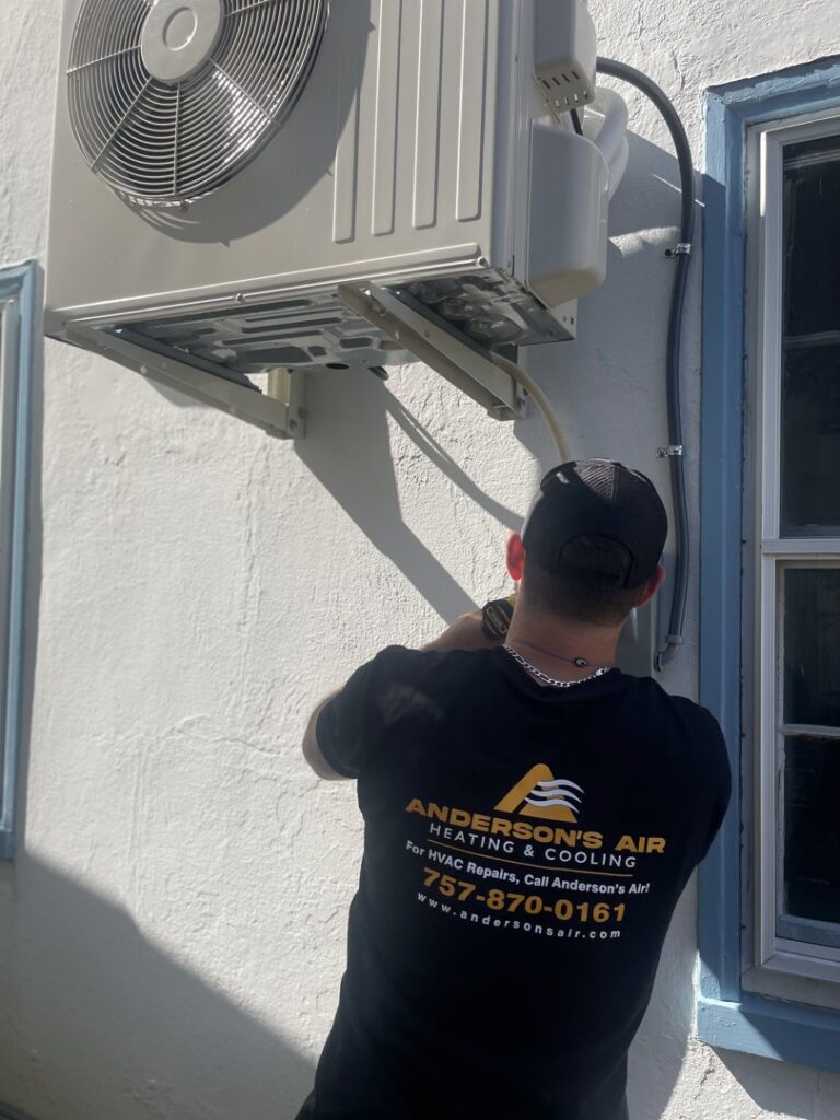An HVAC technician installing an outdoor mini-split unit for Anderson's Air in Newport News, VA