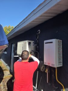 An HVAC technician from Liberty Air Heating and Cooling installing a mini-split outdoor unit in Saint Petersburg, FL.