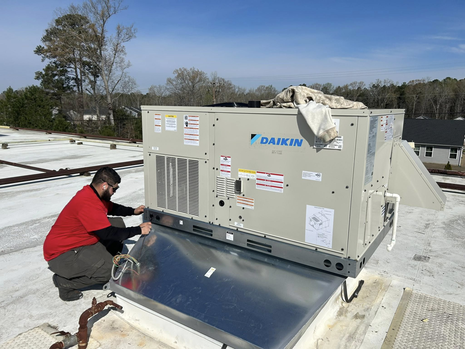 An HVAC technician installing a new Daikin rooftop unit for Angel's Air Heating & Cooling, LLC in Lakeland, FL.