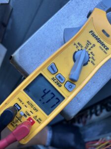 An HVAC technician taking a multimeter reading during service by Krantz Kooling & Heating in West Columbia, SC