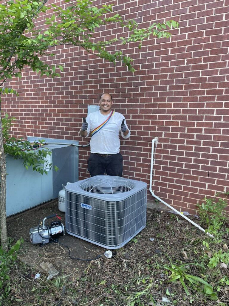 An HVAC technician from KMC Heating and Cooling LLC giving a thumbs up next to a newly installed Tempstar AC unit in Clarksville, TN.