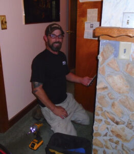 An M&B Heating and Air technician on a job site with tools, ready to perform HVAC service in Charleston, SC.