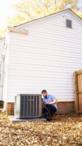 An HVAC technician performing service on an outdoor air conditioning unit for General Air Conditioning Service Corp in Greenville, SC.